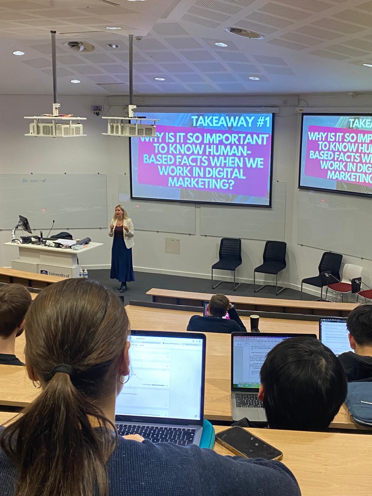 Katherine Pinner speaking to students in a university lecture theatre